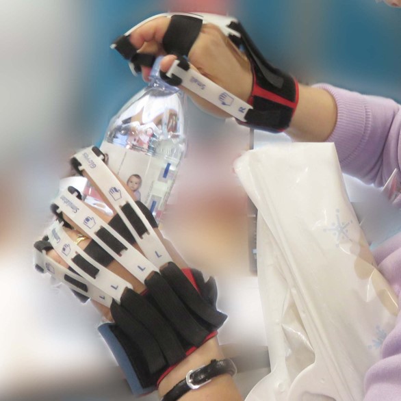 photograph of someone opening a water bottle while wearing Cambridge Simulation Gloves